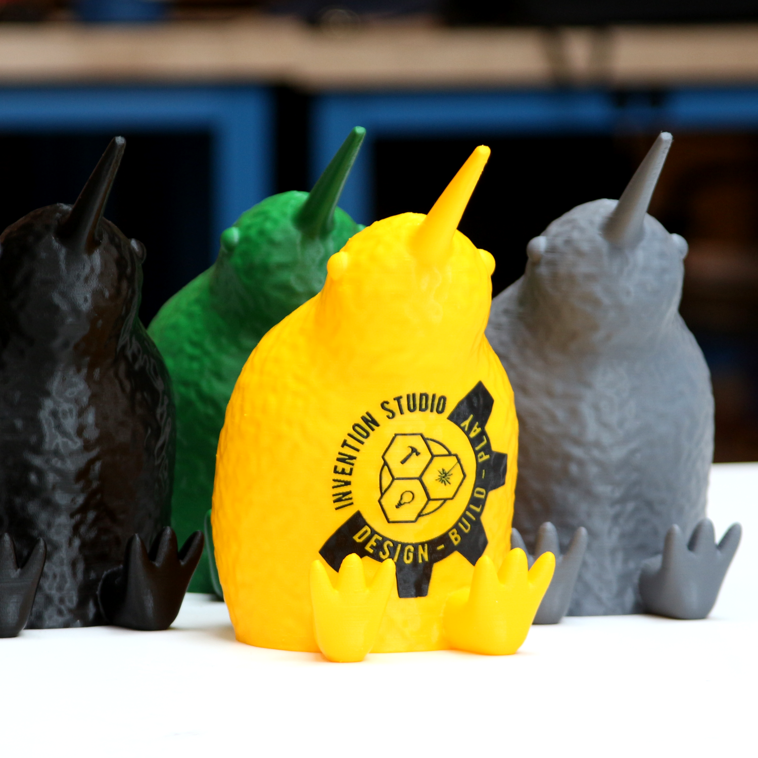 A photo of a 3D printed kiwi with the invention studio logo